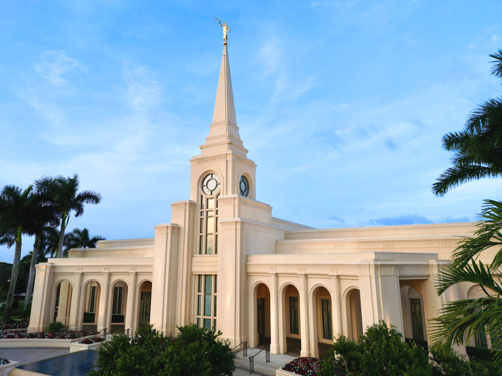 The Fort Lauderdale Florida Temple with palm trees and a blue sky.
