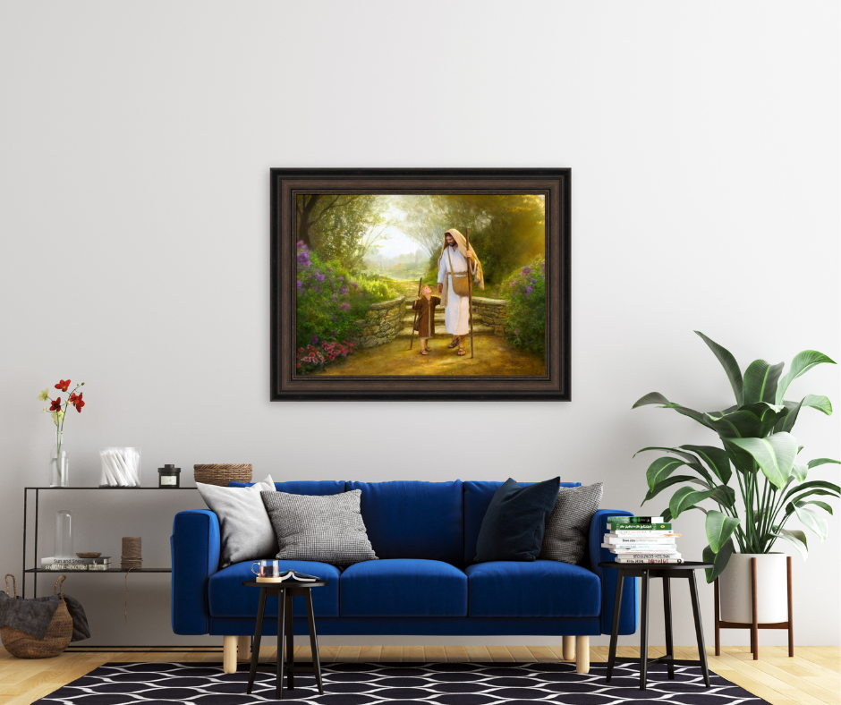  A serene image of Jesus holding hands with a child, beautifully captured within a picture frame hanging in a cozy living room setting.