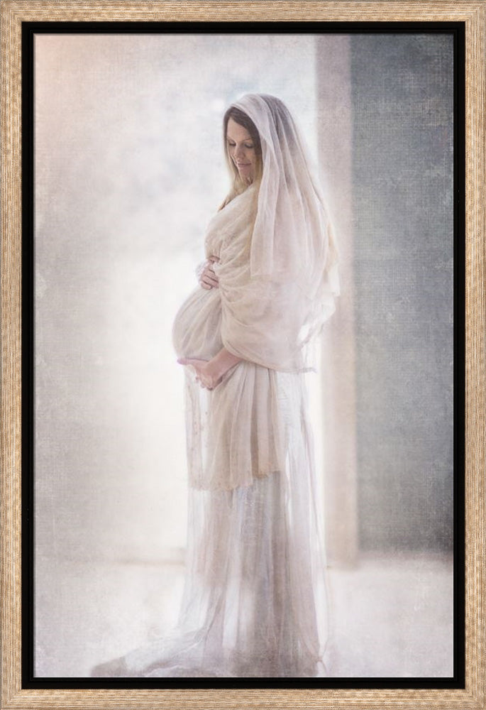 Marry wearing all white holding her pregnant belly.