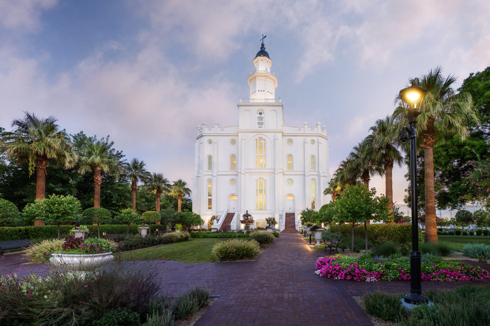 The St. George Utah Temple with a path lined with palm trees.