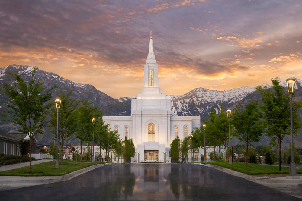 The Orem Utah Temple with the sunrise over the mountains.