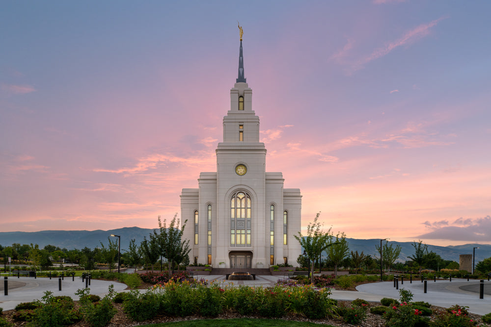 The Layton Utah Temple with a purple sunrise.