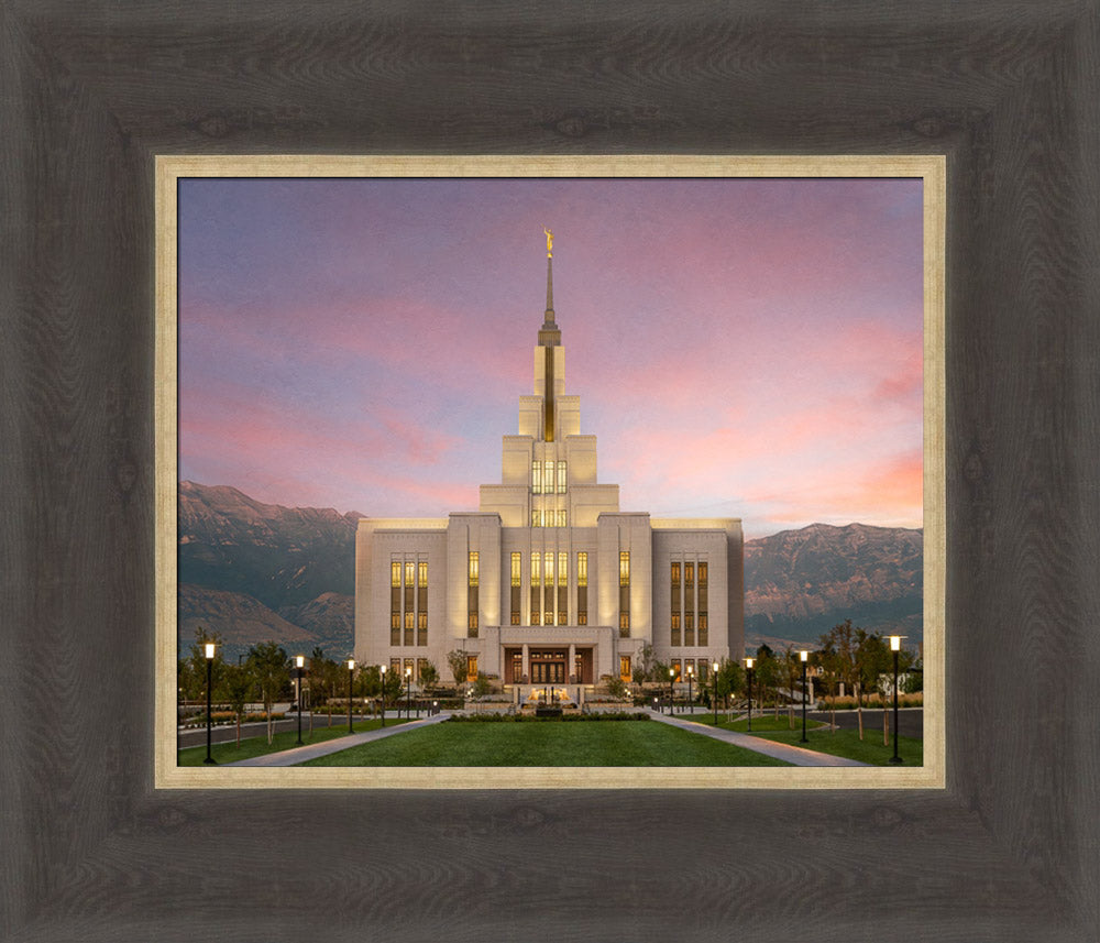 The Saratoga Springs Utah temple from the front with mountains and a sunset.