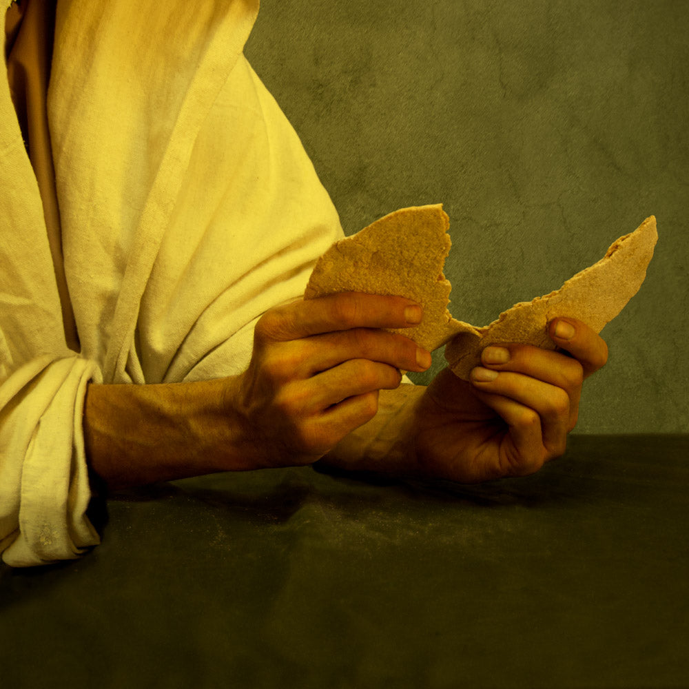 Jesus Christ breaking bread for the sacrament.