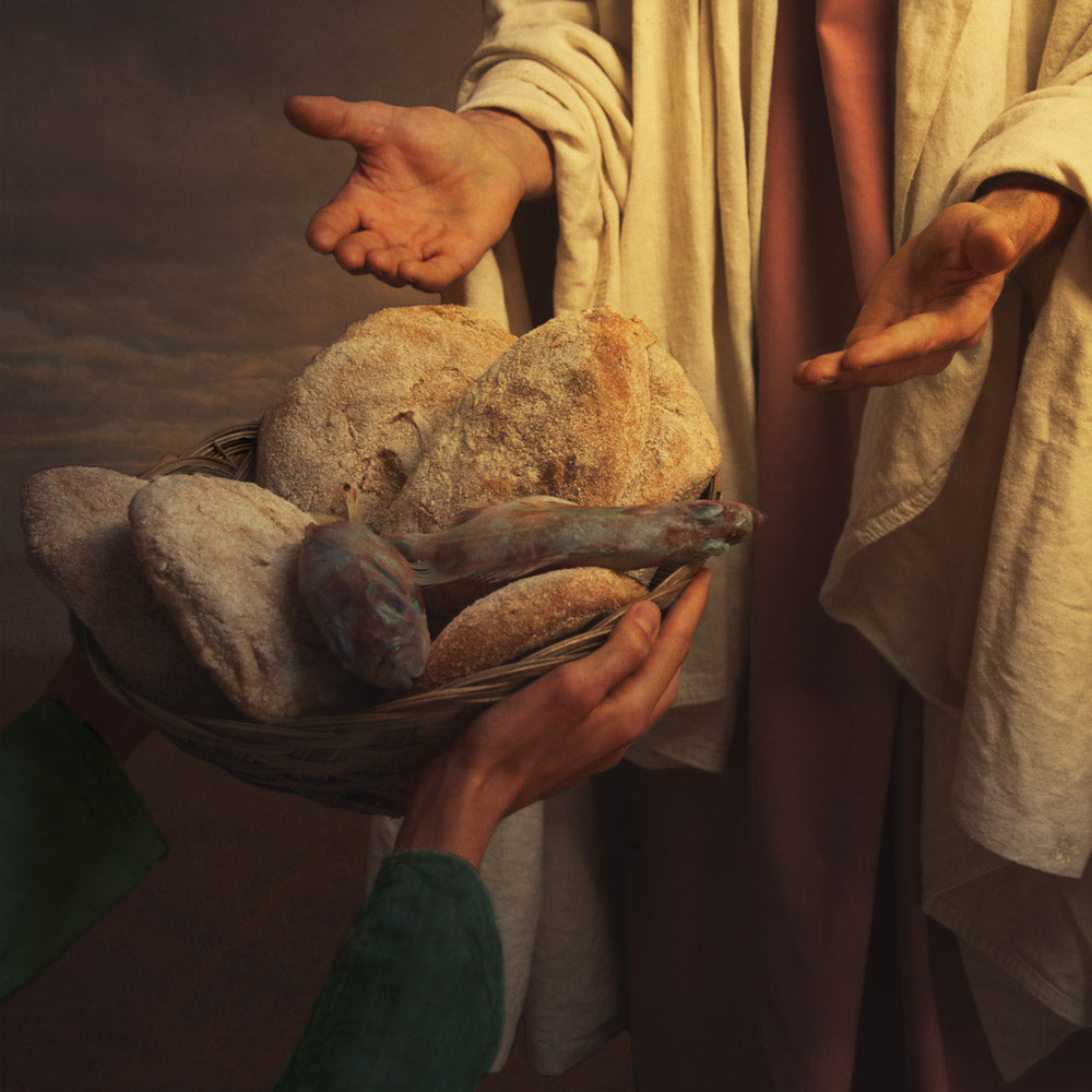 Jesus feeding the five thousand with 5 loaves of bread and 2 fishes.