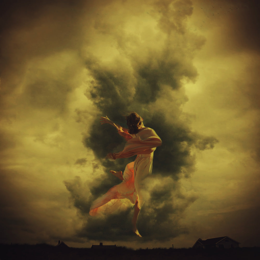 A young woman dances in the sky amid swirling storm clouds.