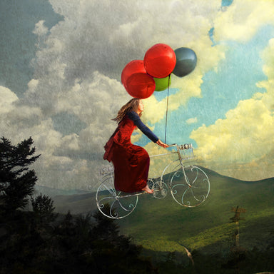 A young woman in a red dress pedals a bicycle into the air. Balloons are tied to the handlebars.