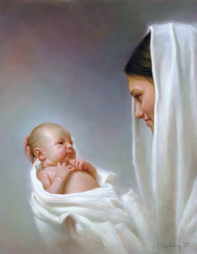Women with white shall on her head looking at baby she is holding.