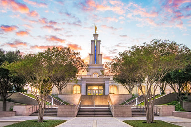 The sun rises behind the San Antonio Temple. Golden light pours from its windows.