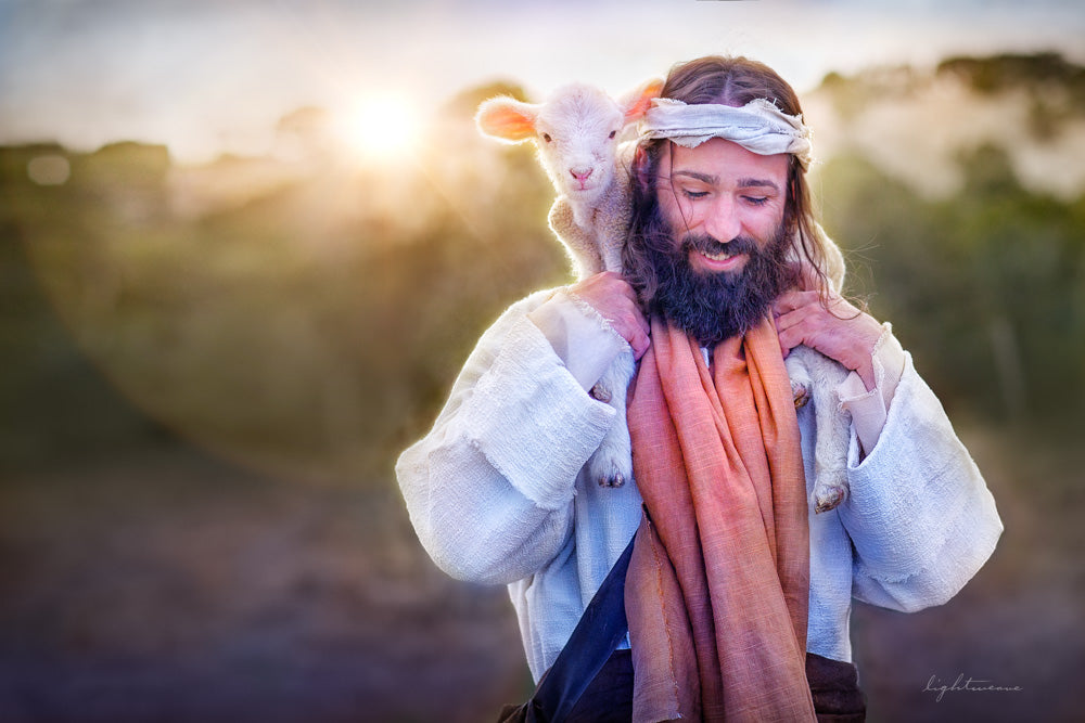 Jesus with a lamb on his shoulders and light shining in the background.