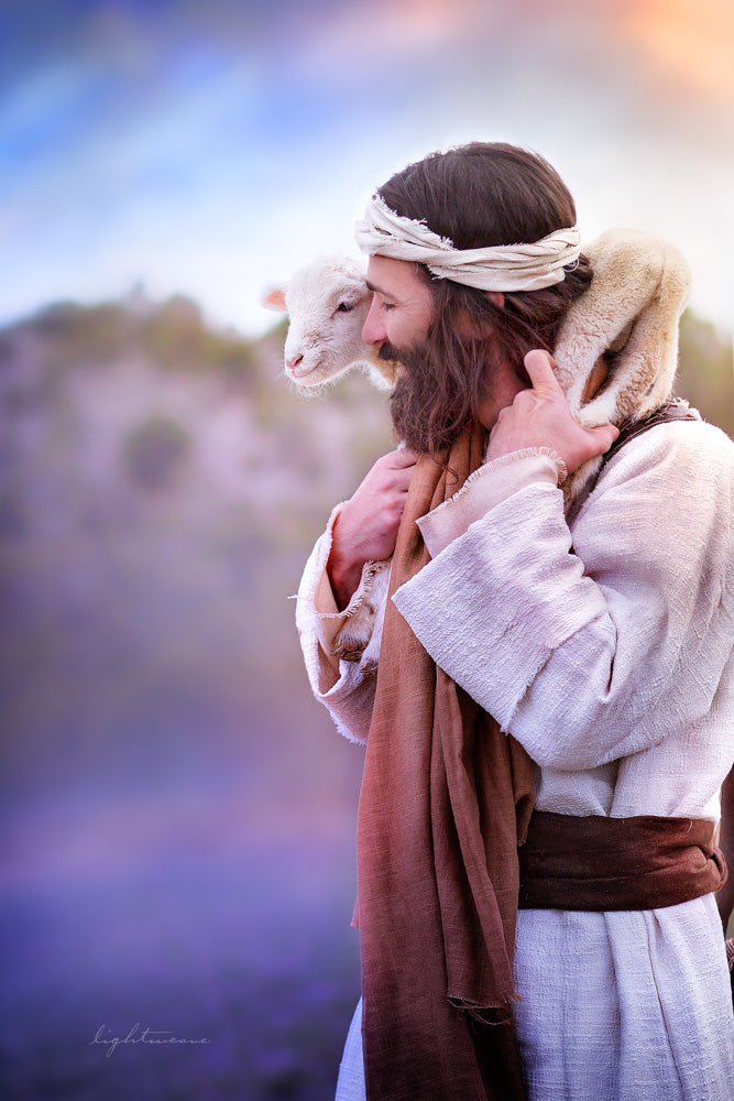 Jesus smiling holding a lamb on his shoulders.