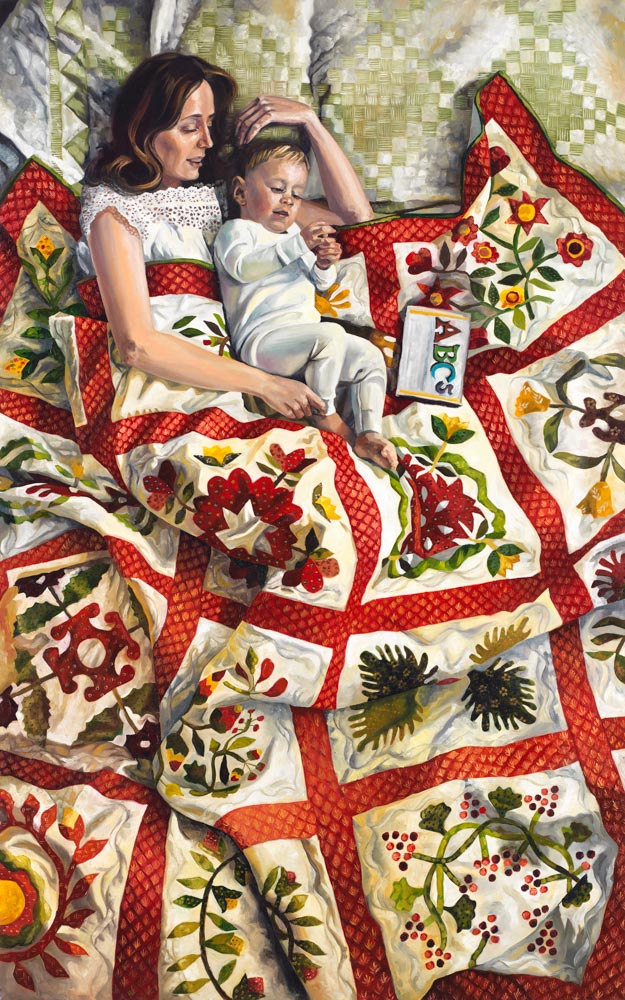 A mother and young child lay with a quilt and a book.
