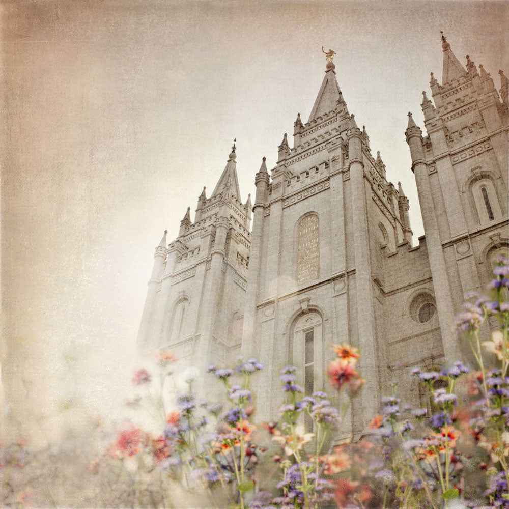 Salt Lake Utah Temple with red and purple wild flowers.