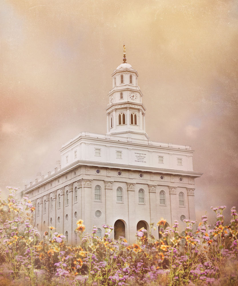 Nauvoo Illinois Temple with yellow and purple flowers.