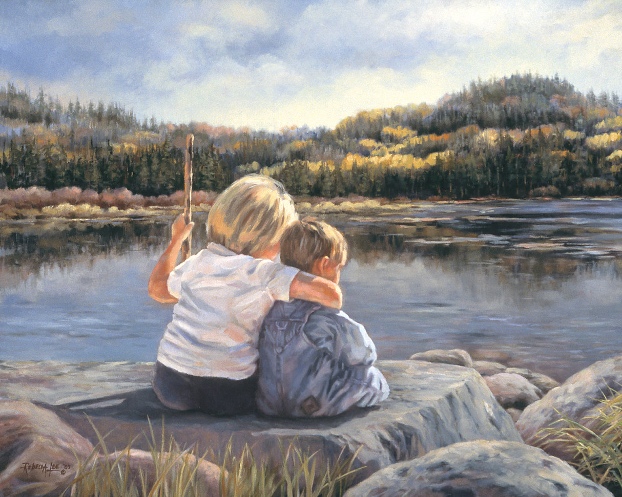 Two young children sitting on a rock looking out at a lake.