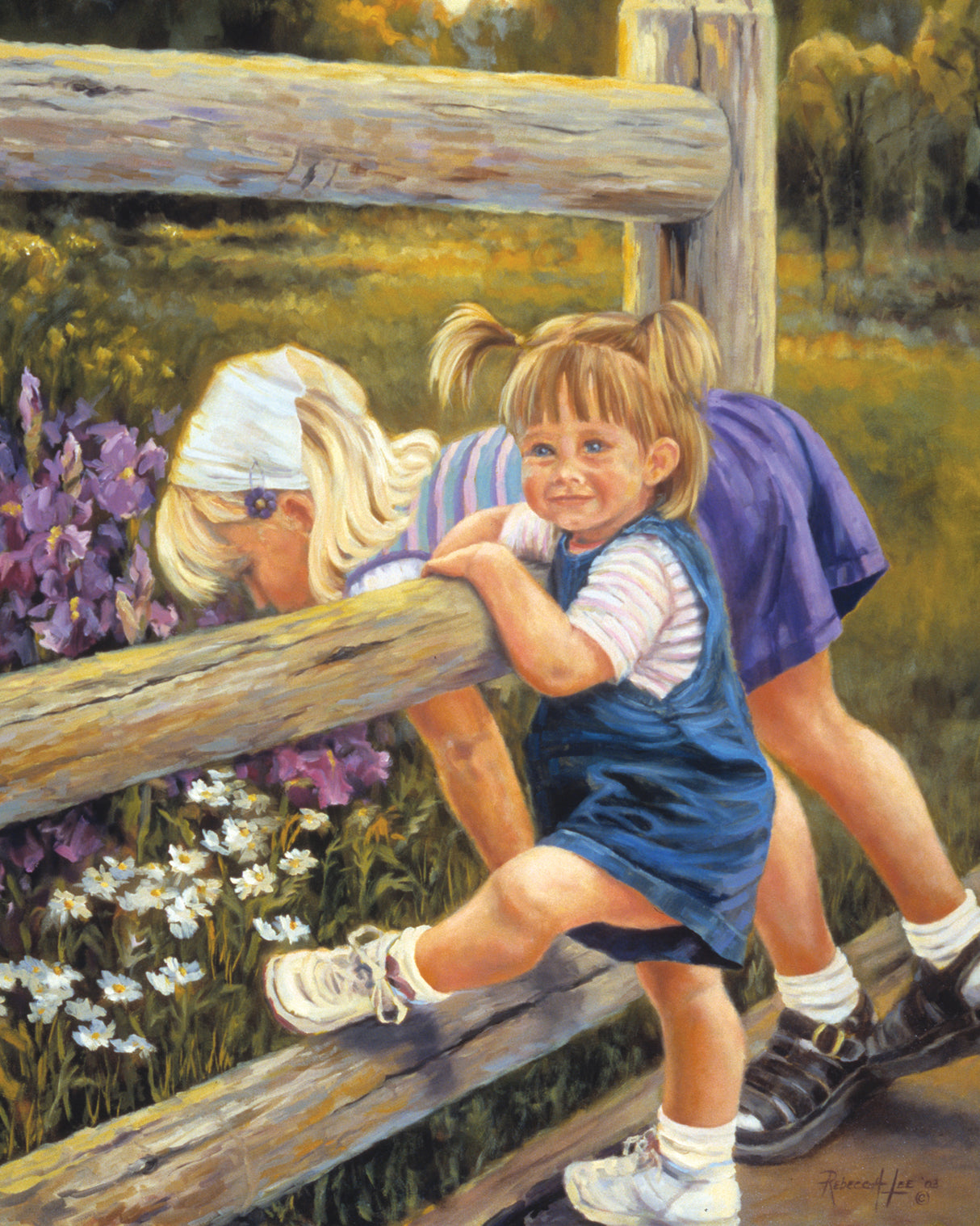 Two young girls leaning over a fence looking at purple flowers.