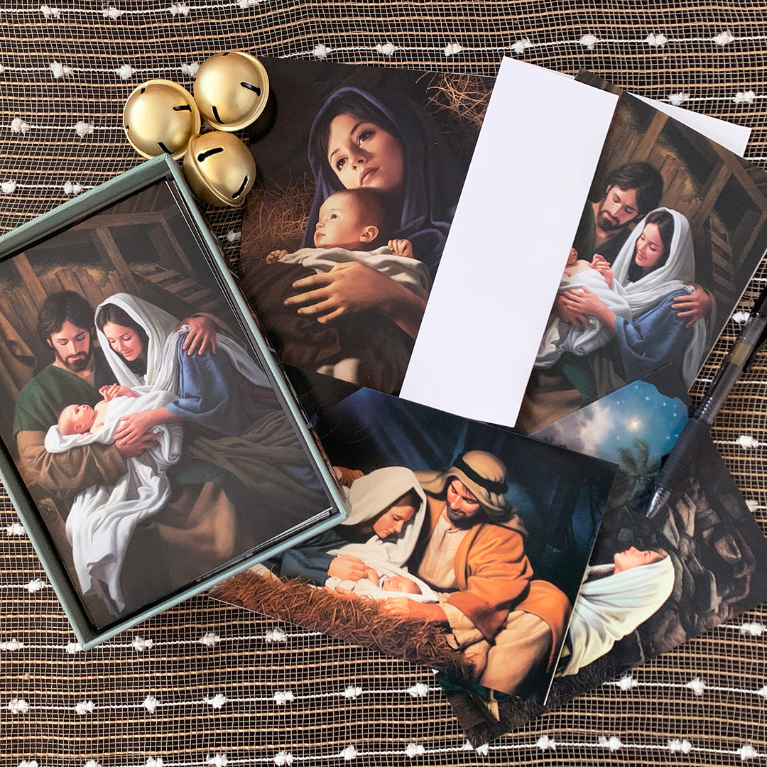 A box of Simon Dewey Christmas cards featuring an image of Jesus with his family, perfect for holiday greetings.