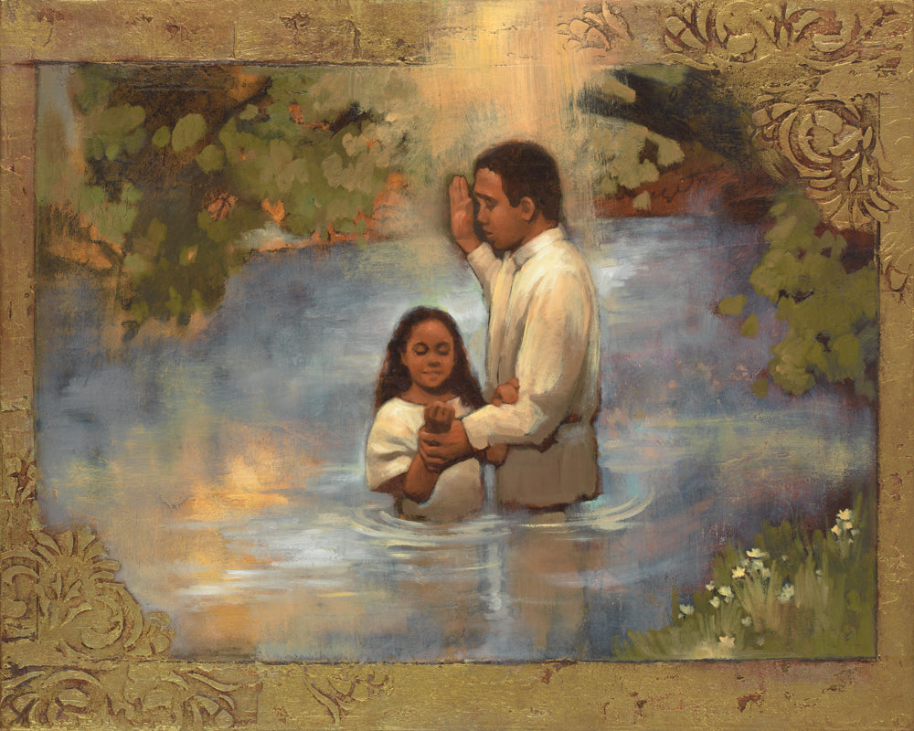 A framed religious painting depicting a man and a young child standing in shallow water, with a radiant light above them and leafy trees around the scene. The artwork is enclosed in an ornate gold-toned frame.
