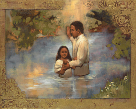 A framed religious painting depicting a man and a young child standing in shallow water, with a radiant light above them and leafy trees around the scene. The artwork is enclosed in an ornate gold-toned frame.