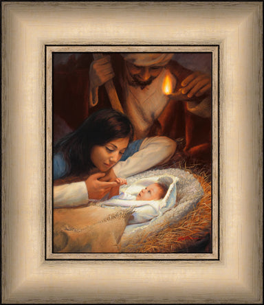Mary holding baby Jesus' hand with Joseph watching over the manger scene