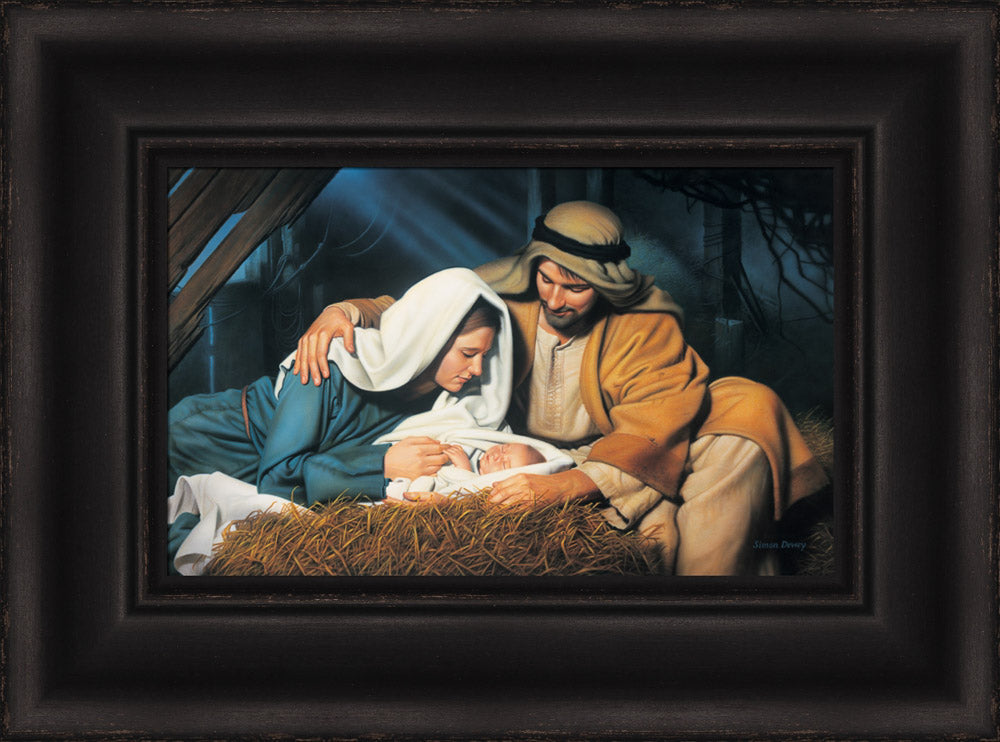 Joseph and Mary look at baby Jesus as he sleeps in the manger.