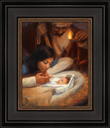 Mary holding baby Jesus' hand with Joseph watching over the manger scene