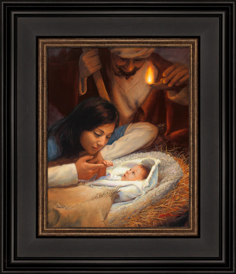 Mary holding baby Jesus' hand with Joseph watching over the manger scene