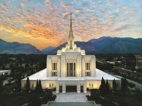 The Ogden Utah Temple with the sunrise over the mountains.