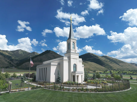 The Star Valley Wyoming Temple with the mountains and clouds.
