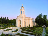The Feather River California Temple with trees and a clear sky.