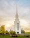 The Twin Falls Idaho Temple with a bright sunburst in the sky.