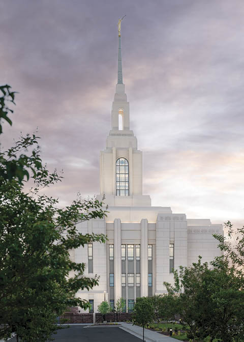 The Red Cliffs Utah Temple at sunset with purple skies.