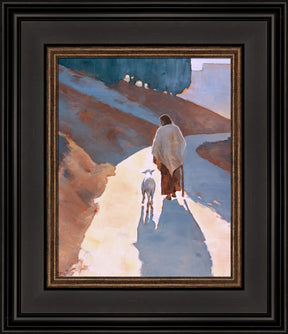 Jesus Christ walking down a path with a sheep.