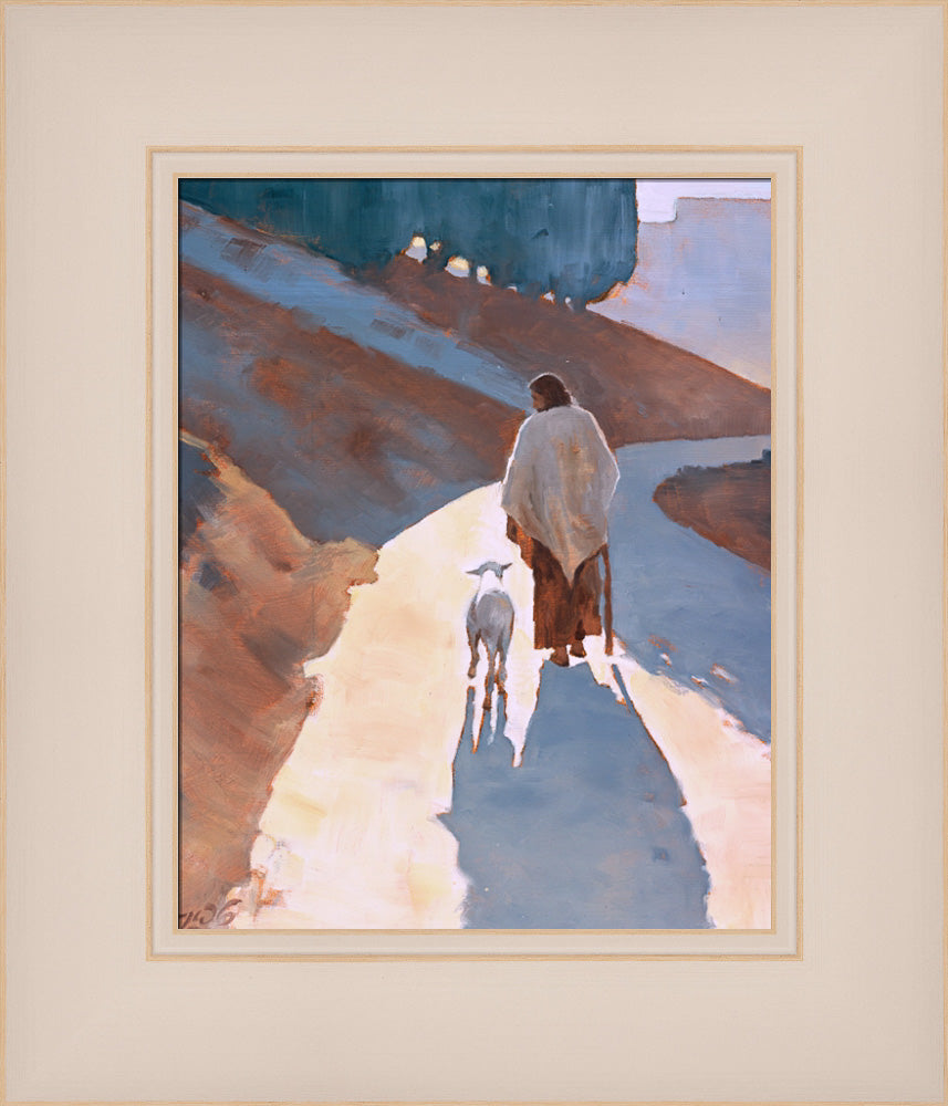 Jesus Christ walking down a path with a sheep.