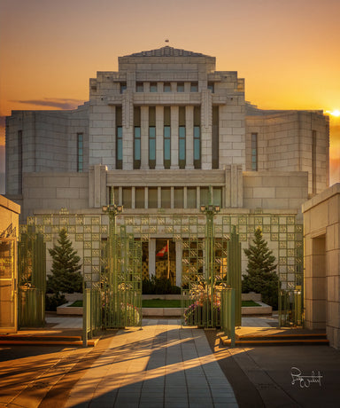 The Cardston Alberta temple viewed from the front in the light of the rising sun.