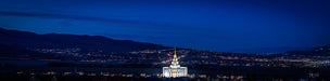 The Saratoga Springs Utah Temple at night with city lights.