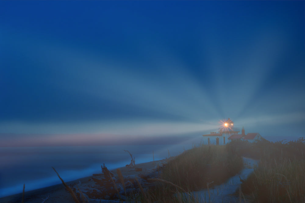 A lighthouse shining into the dark night.