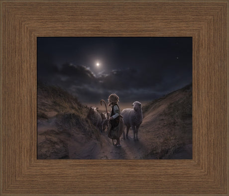 Young shepherd boy standing alone with sheep looking up toward the star.