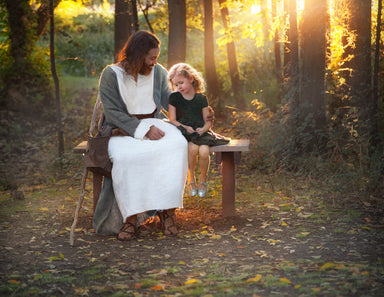 Jesus sitting on a bench with a little girl.