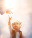 A little child reaches for the hand of Christ.
