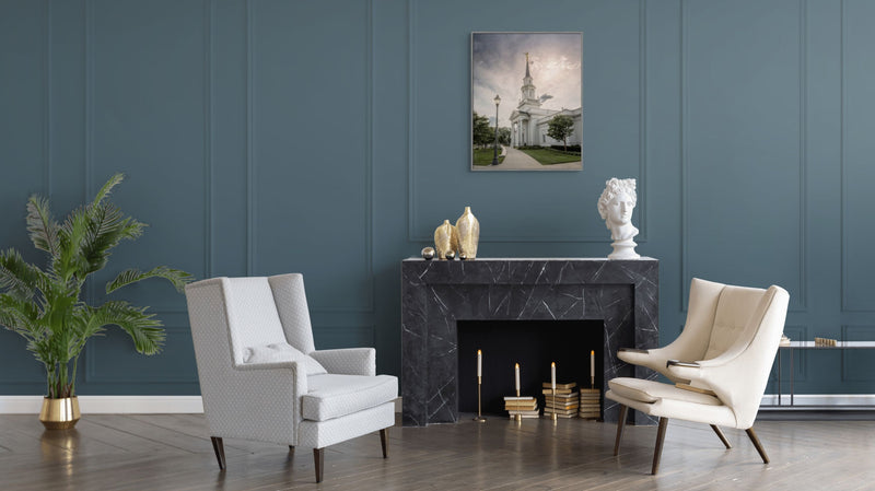 Modern living room with white armchairs, a fireplace, and decorative items.