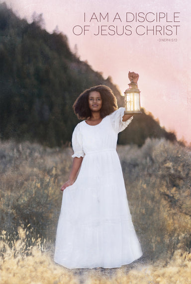 A woman in a white dress holds up a lantern.