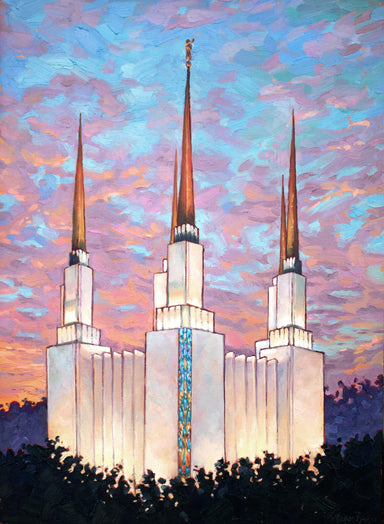 The Washington DC Temple spires rising up against a blue and pink sky. 