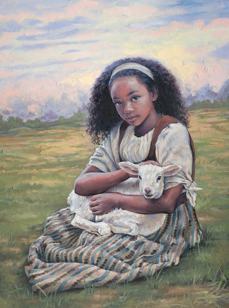 A young girl holding a lamb.