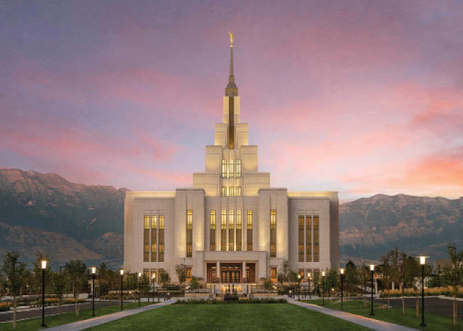 The Saratoga Springs Utah temple from the front with mountains and a sunset.