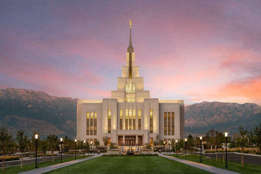 The Saratoga Springs Utah temple from the front with mountains and a sunset.