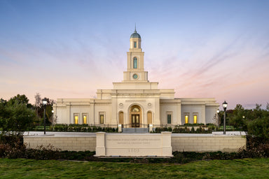 The Bentonville Arkansas temple with a pink and blue sky.