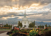 The Orem Utah Temple with light shining through the clouds.