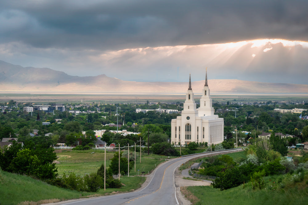 The Layton Utah temple in the landscape on a cloudy day.