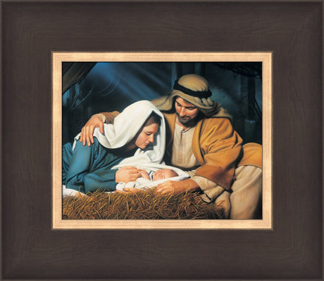 Joseph and Mary look at baby Jesus as he sleeps in the manger.